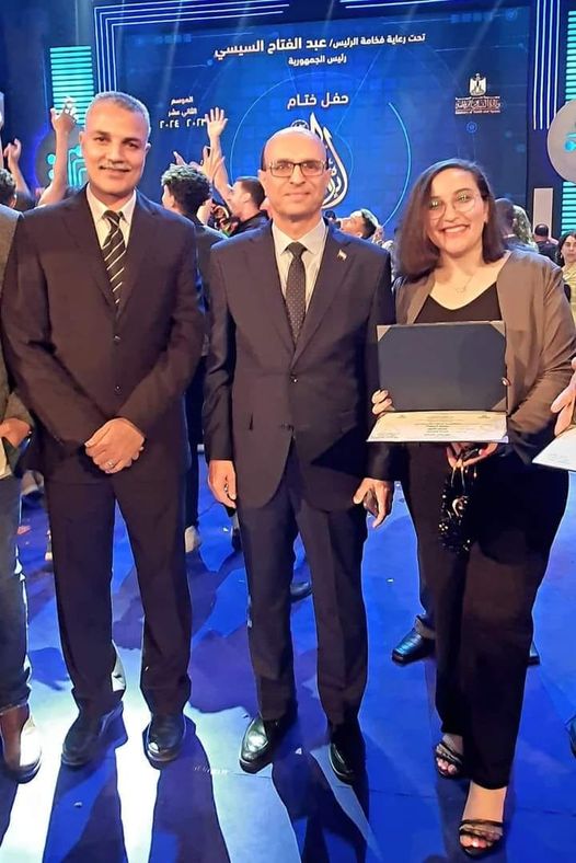 A souvenir photo with Professor Dr. Ahmed El-Menshawy, President of Assiut University, for student Claudia Atef Fayez in the third year - Faculty of Medicine (Cultural Activity Management) after winning and obtaining first place in the field of short stories.